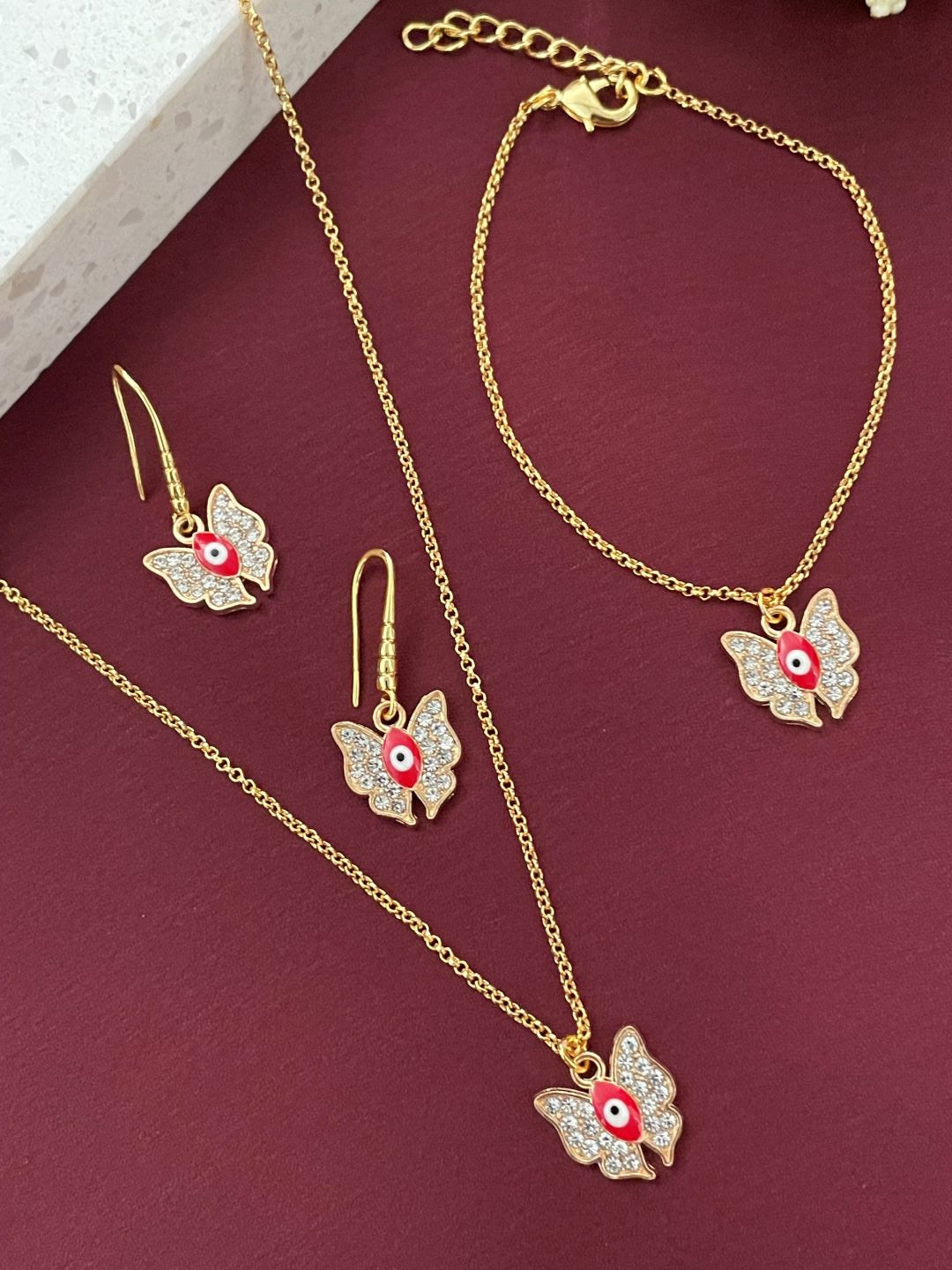 Red Evil Eye AD Butterfly Pendant in Gold Chain with Dangling earrings & Adjustable Bracelet