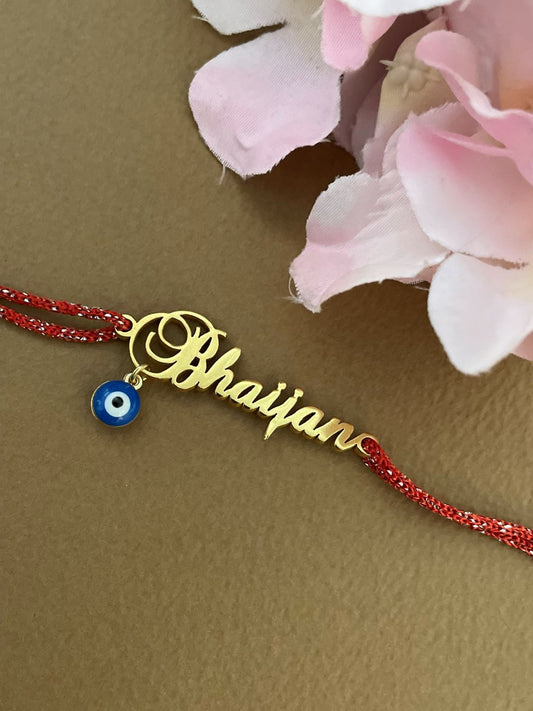 Customized Gold Plated Name Rakhi Pendant With Red Thread and Blue Evil Eye