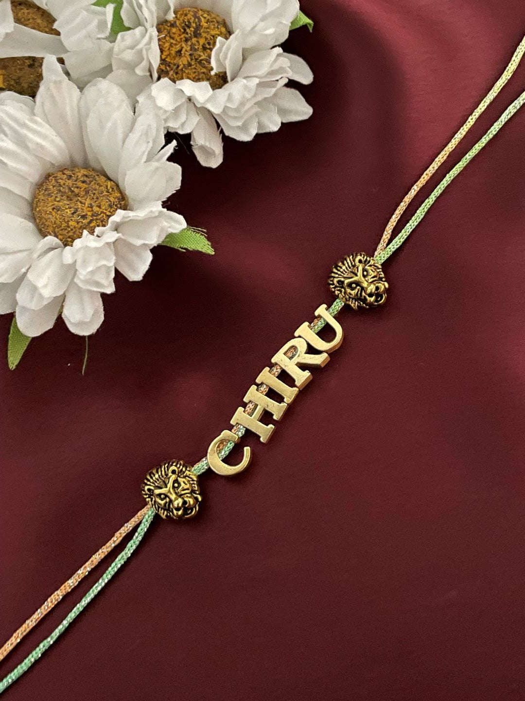 Gold Plated Name Rakhi With 2 Lion Charms