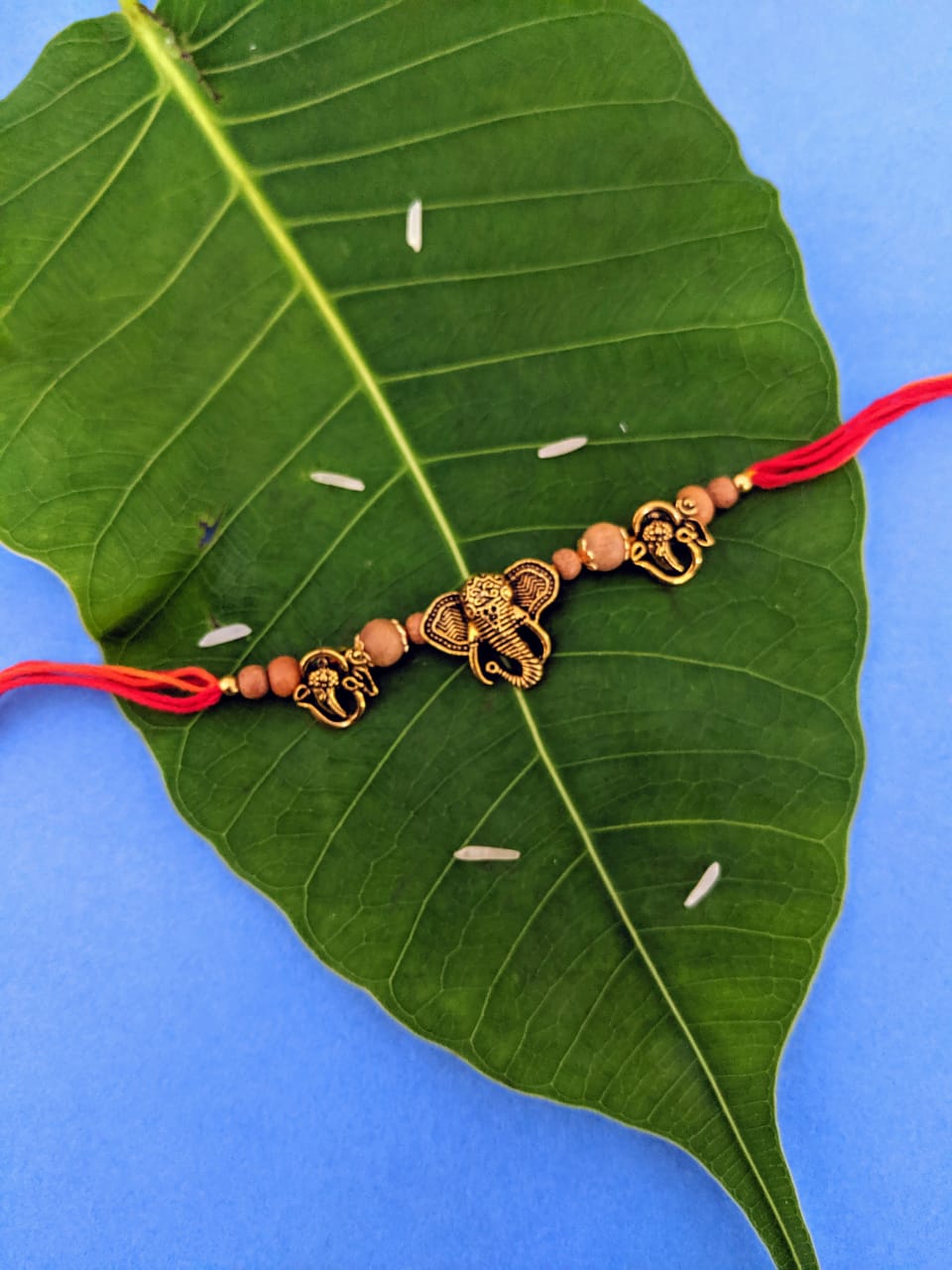 Antique Rakhi Designs Om/Ganesha Face with Tulsi Beads Pendant