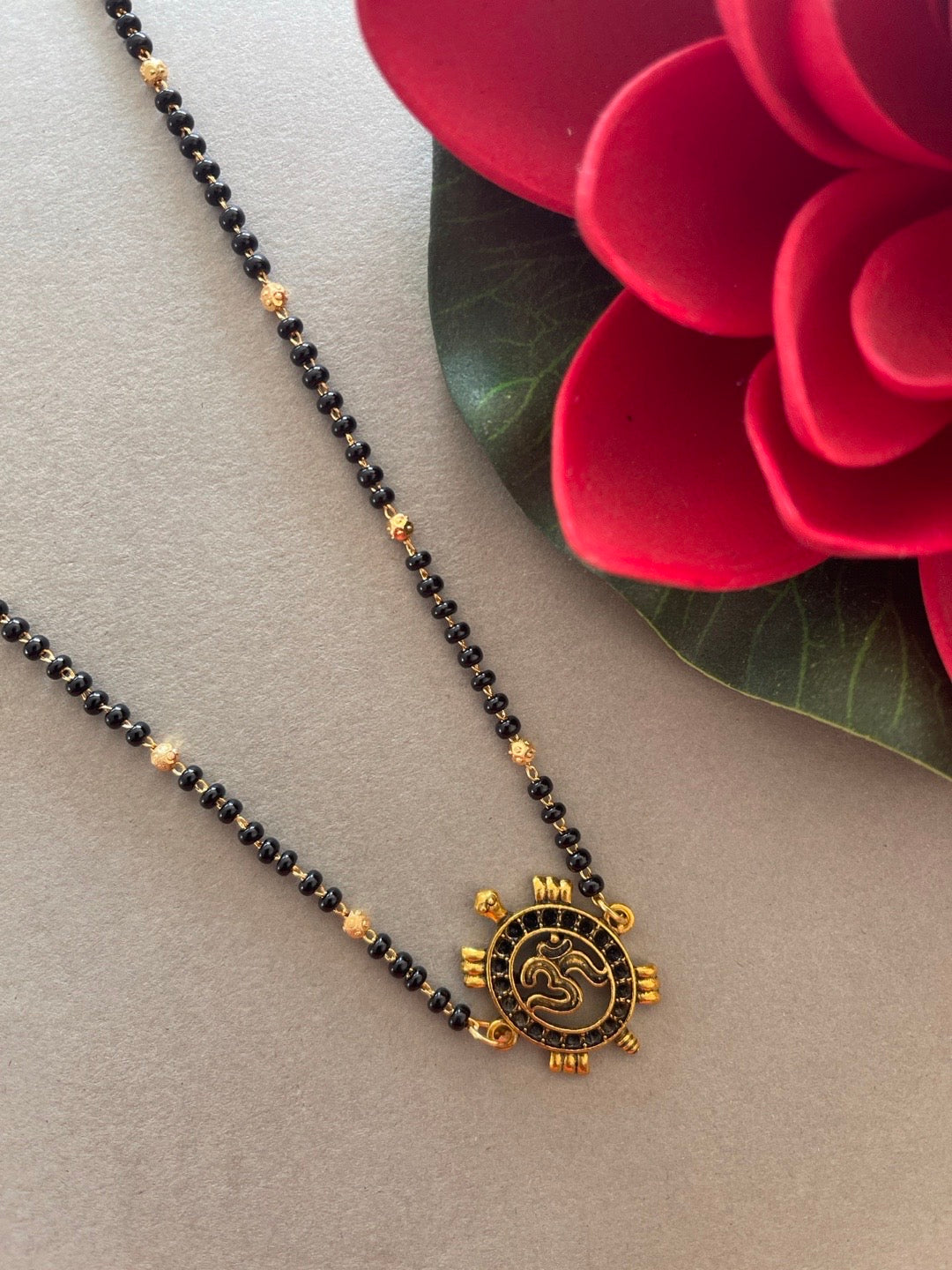 Simple Modern Short Mangalsutra Designs Gold Plated Tortoise/Om Pendant Gold And Black Beads Chain