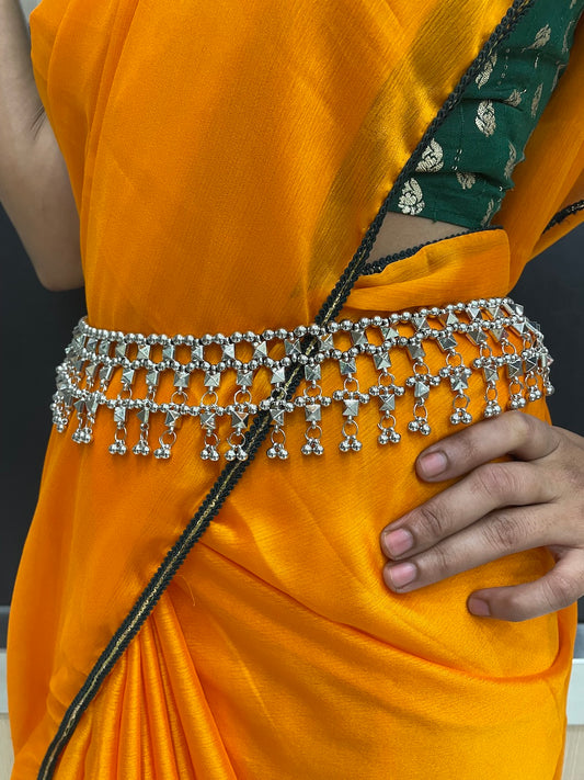 Stylish oxidized kamarband with tribal-inspired design, paired with a bohemian lehenga for a Garba night.