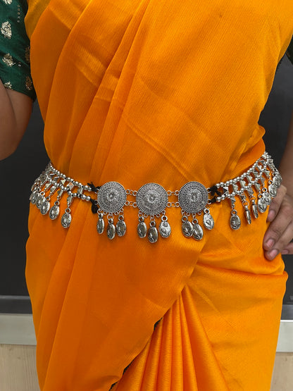 Festive kamarband with kundan accents.