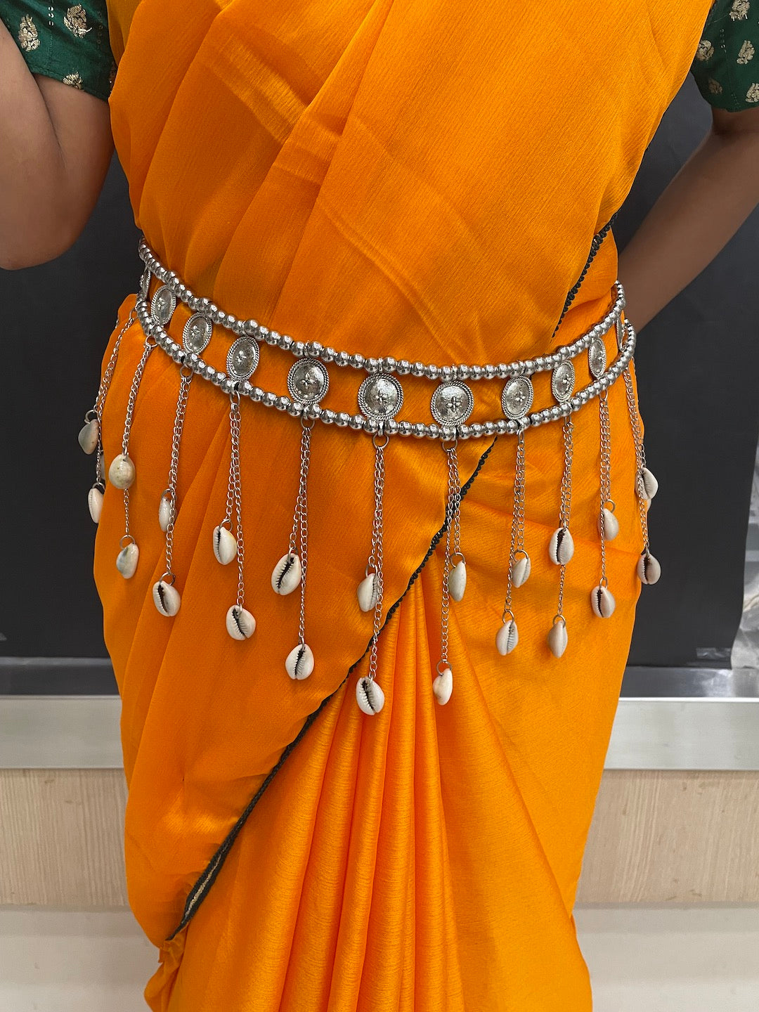 Pearl kamarband on traditional saree.