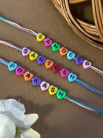 Custom Name Rakhi in Pastel Color Heart Shaped Beads