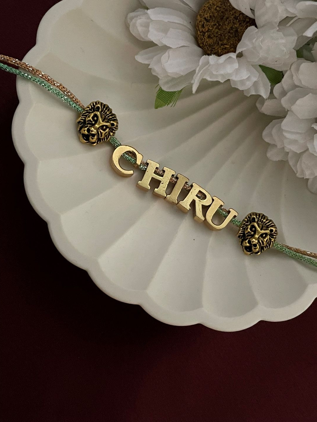 Gold Plated Name Rakhi With 2 Lion Charms 