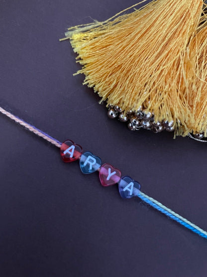 Custom Name Rakhi in Pastel Color Heart Shaped Beads